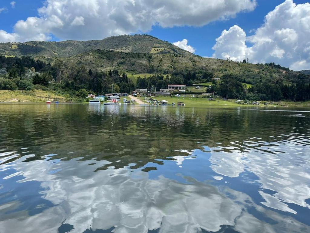 a large body of water with a mountain in the background at Chalet Amadeus Guatavita in Guatavita