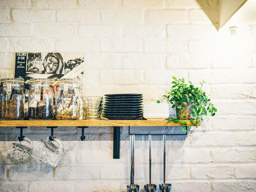 a wooden counter with dishes on a white brick wall at Hotel Pacific Kanazawa in Kanazawa