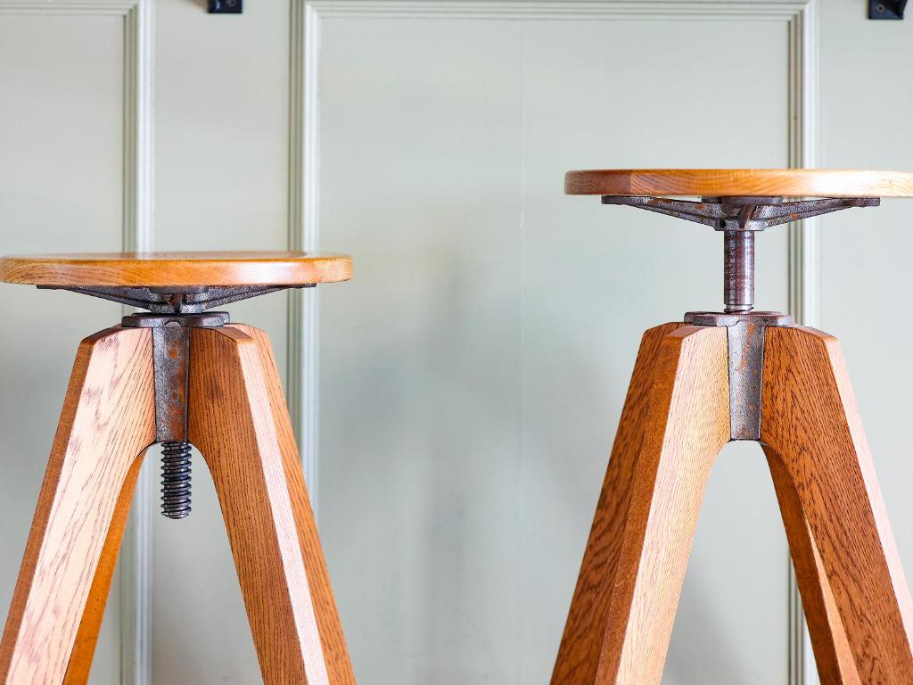 a pair of wooden stools with wooden legs at Hotel Pacific Kanazawa in Kanazawa