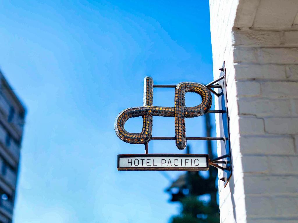 a sign for a hotel packet hanging on a building at Hotel Pacific Kanazawa in Kanazawa