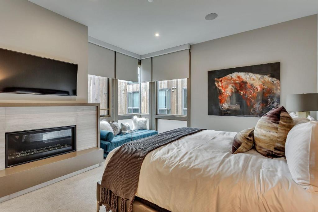 a bedroom with a large bed and a fireplace at Premium Two Bedroom apartment hotel in Park City