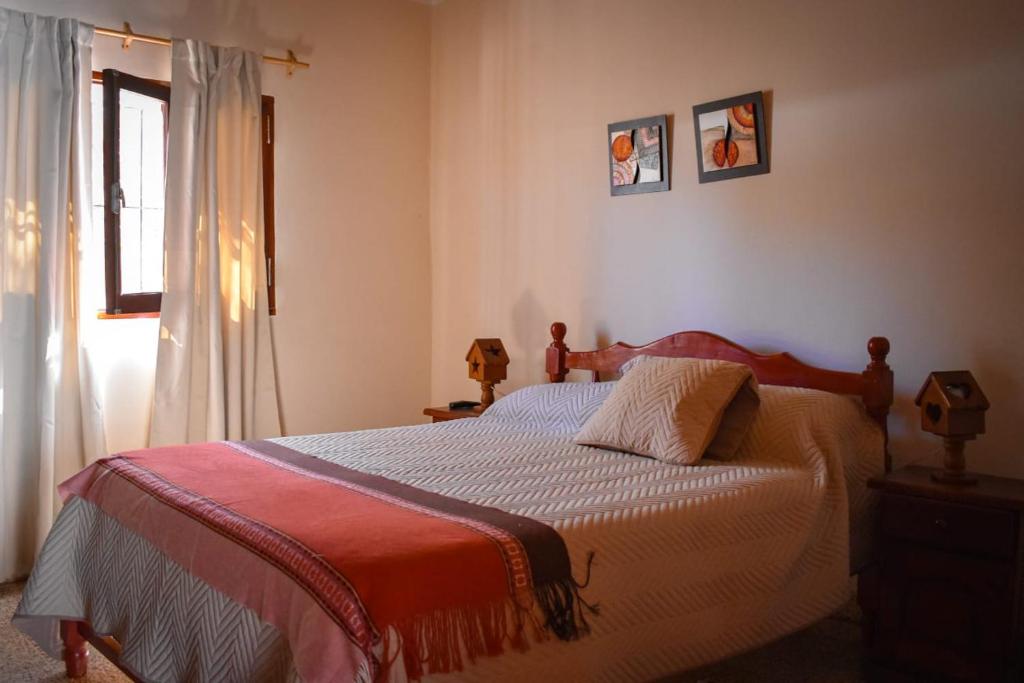 a bedroom with a bed and a window at HOSPEDAJE LA CASONA DE CACHI in Cachí