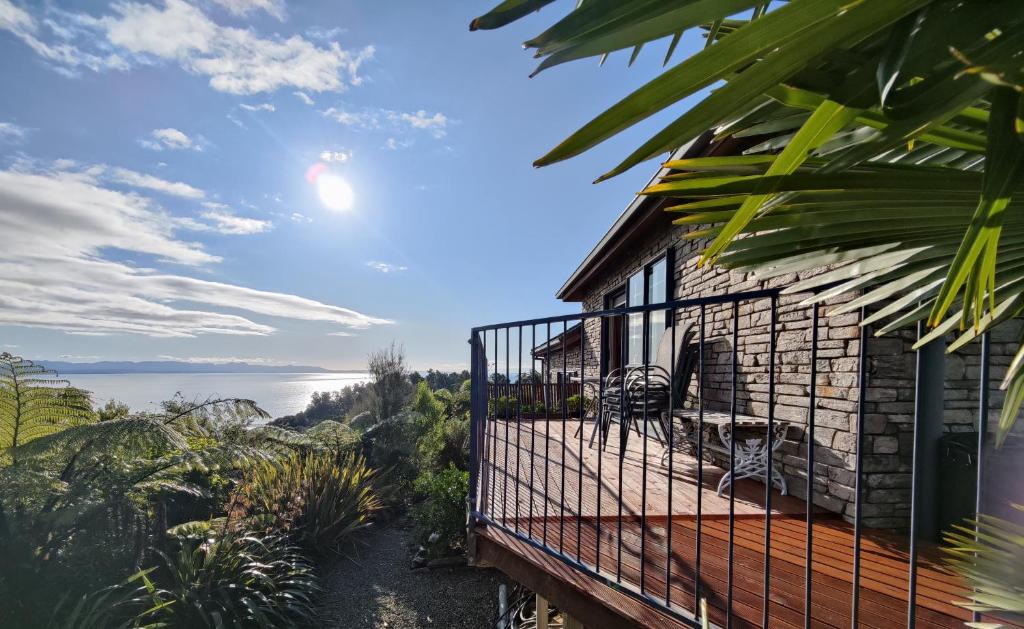 a house with a balcony with a view of the ocean at Beau Vista Pohara in Pohara