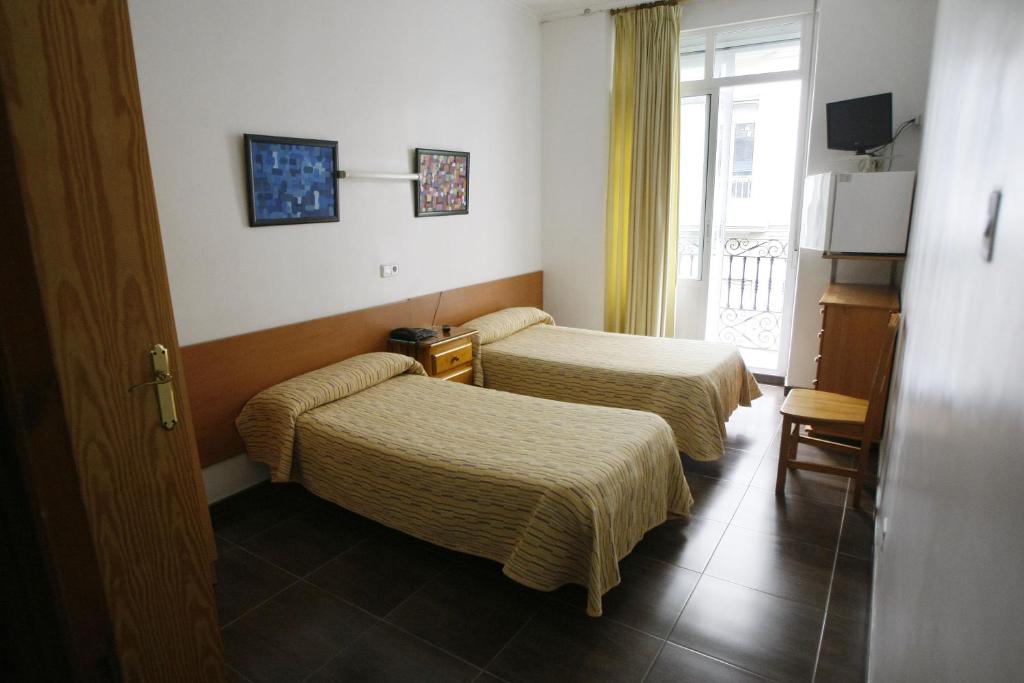 Postel nebo postele na pokoji v ubytování Hostal San Fernando
