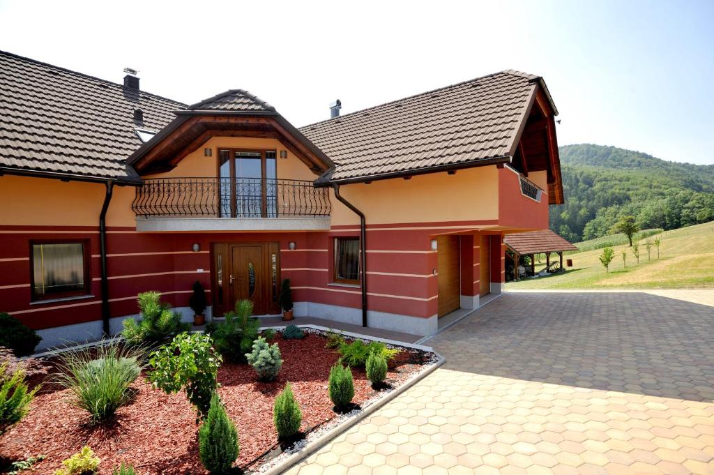 a house with a driveway in front of it at Apartment Anja in Zreče