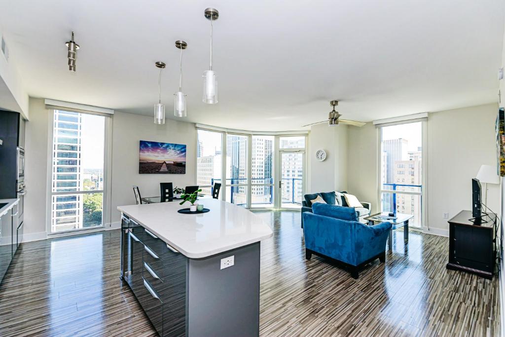 an apartment with a kitchen and a living room at Uptown Charlotte 2BR Furnished Apartments apts in Charlotte