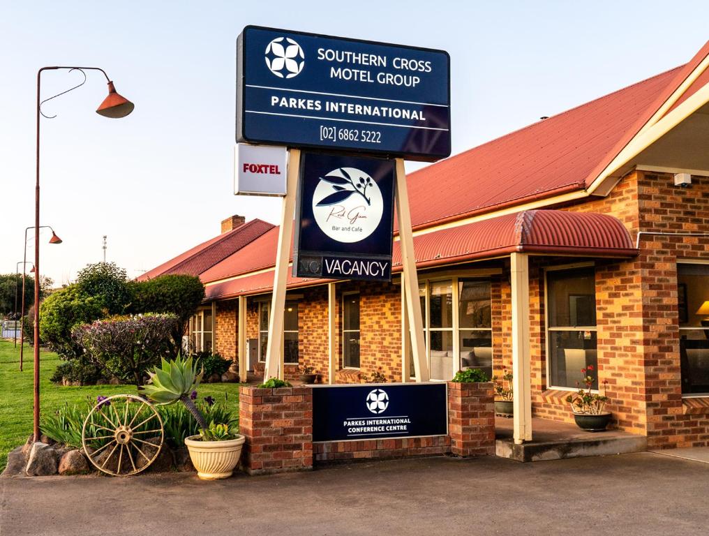 a store with a sign in front of a building at Parkes International in Parkes