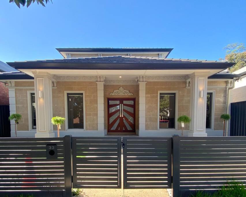 a house with a gate in front of it at New Spacious Luxury 5 Bedroom Mansion in Unley in Unley