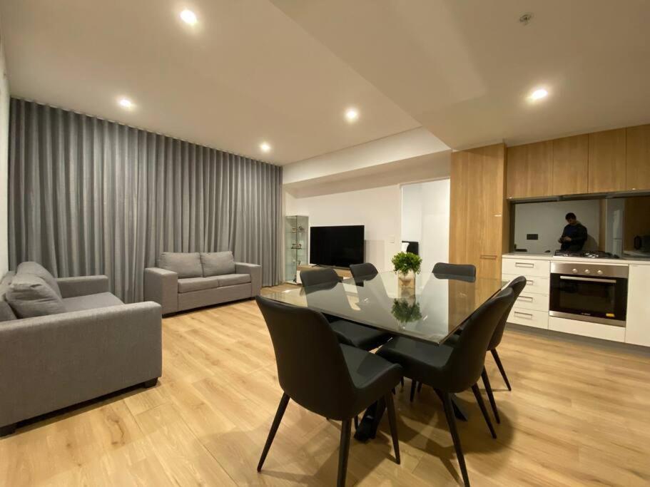 a living room with a table and chairs and a couch at Luxury Disney 3 BR Apt- Pool-Gym-Sauna-Steam Room in Adelaide