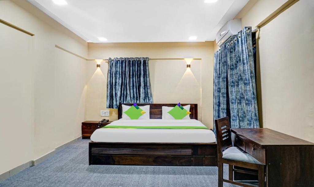 a bedroom with a bed and a desk at Treebo Trend Tulip in Pune