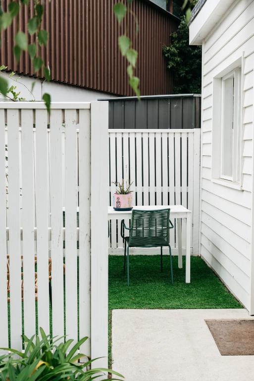 a bench in a yard next to a white fence at Anchor Geelong in Geelong