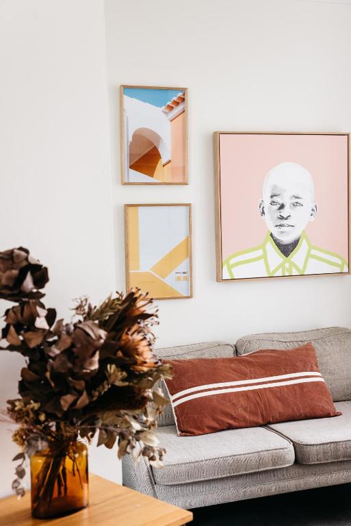 a living room with a couch and pictures on the wall at Anchor Geelong in Geelong