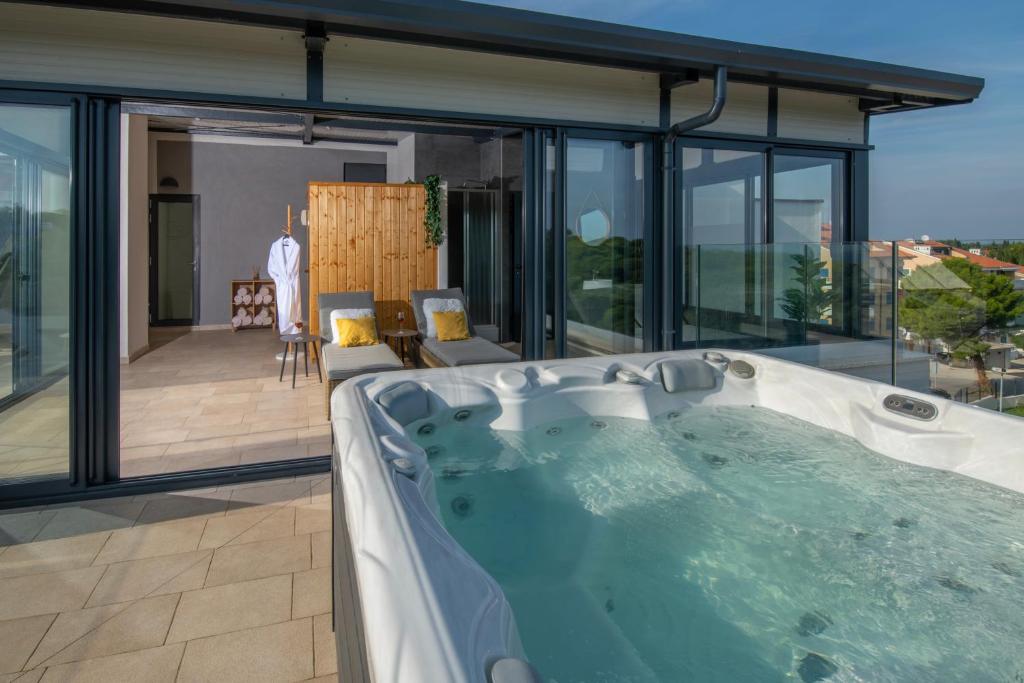 a jacuzzi tub in the middle of a house at Aparthotel Punta Blu - POOL & SPA in Premantura