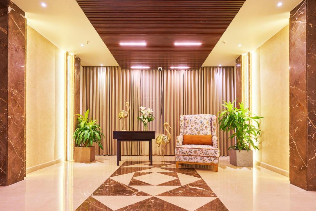 a lobby with a chair and a table at Visthara Hotel in Bengaluru