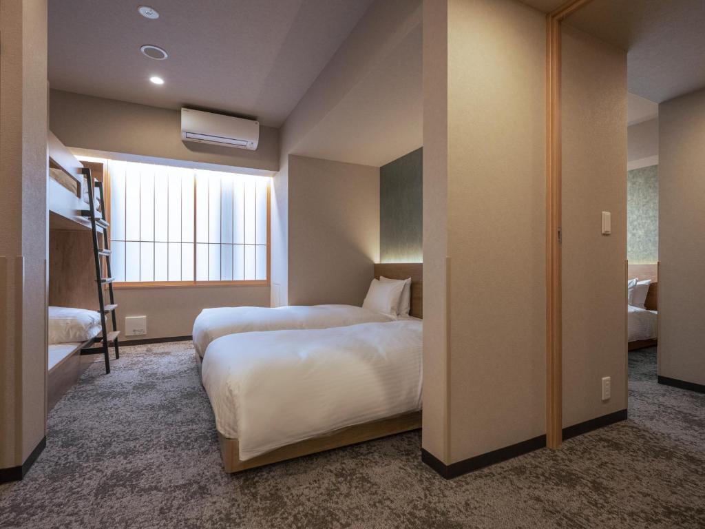 Postel nebo postele na pokoji v ubytování MIMARU Tokyo Ikebukuro