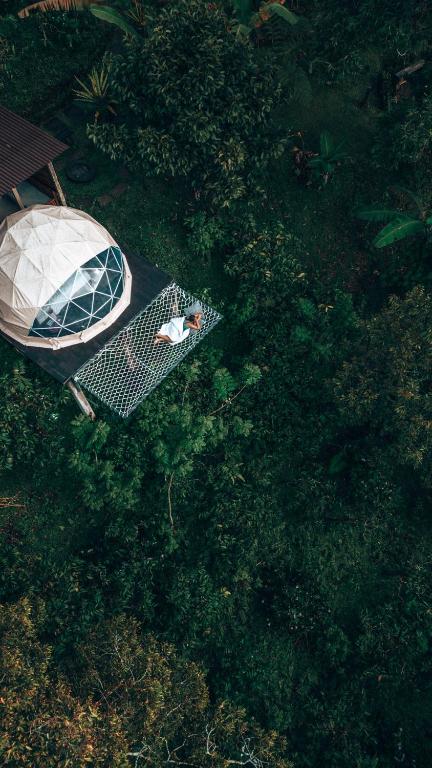 an overhead view of a person sitting on a table at Bali Jungle Camping by Amerta Experience in Tabanan