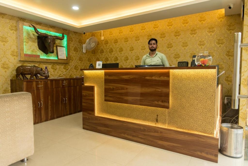 a man standing at a counter in a room at DAS HOTEL in Darjeeling