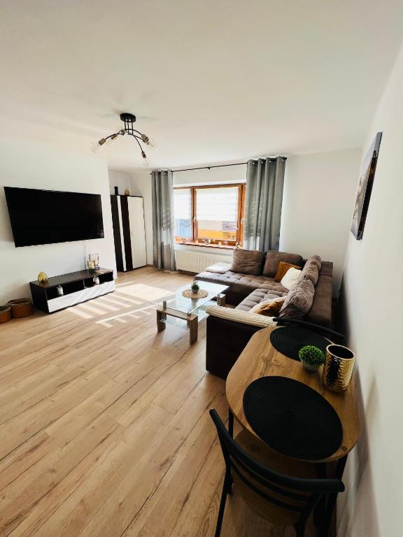 a living room with a couch and a table at Apartament Kolejowa 7 in Nowy Targ