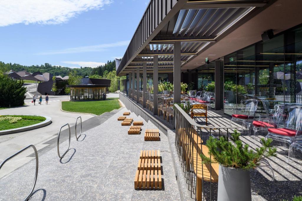 a building with a row of benches in front of it at Terme Olimia - Hotel Breza in Podčetrtek