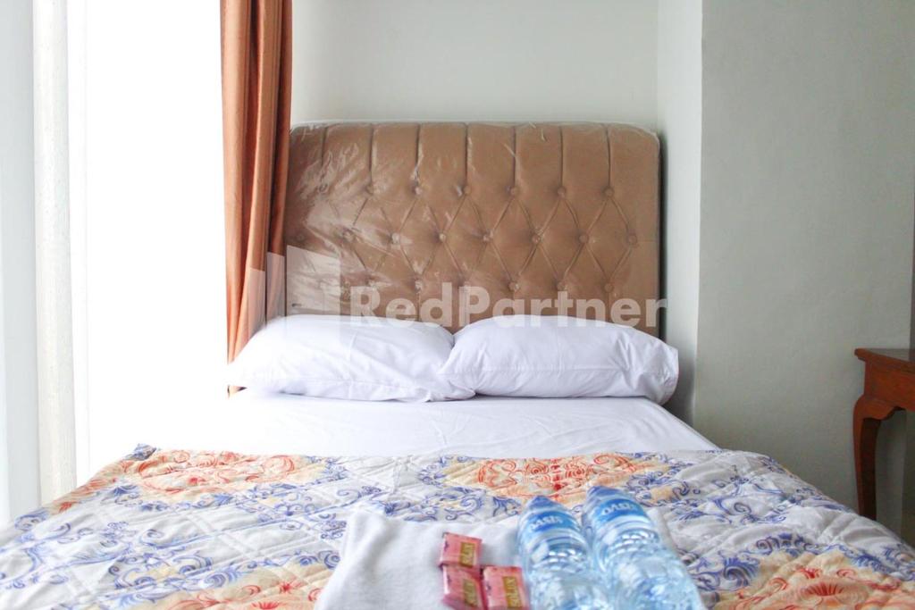Postel nebo postele na pokoji v ubytování Brahma Hotel Mitra RedDoorz