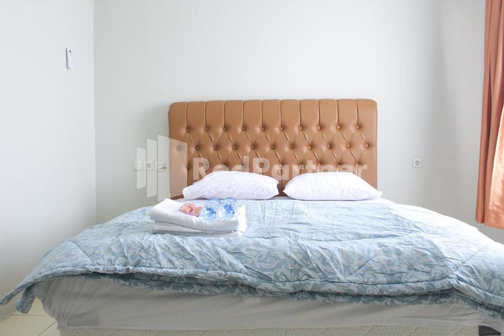 Postel nebo postele na pokoji v ubytování Brahma Hotel Mitra RedDoorz
