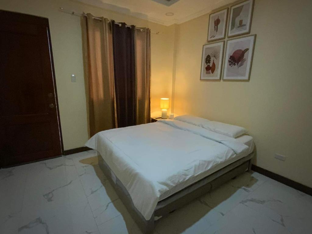a bedroom with a white bed in a room at Divine Resort Corporation in Moalboal