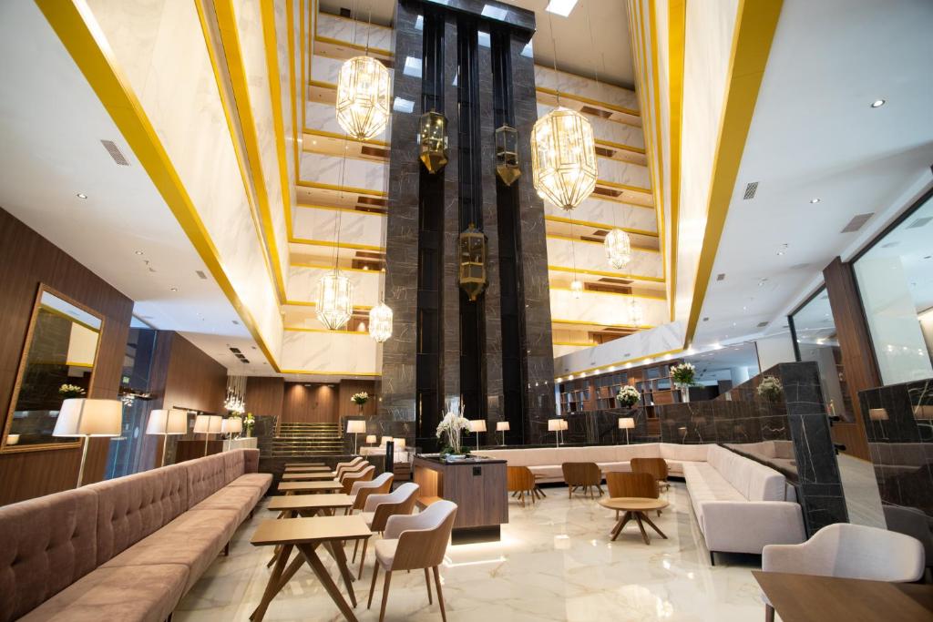 a lobby of a hotel with tables and chairs at Hotel Granada Center in Granada