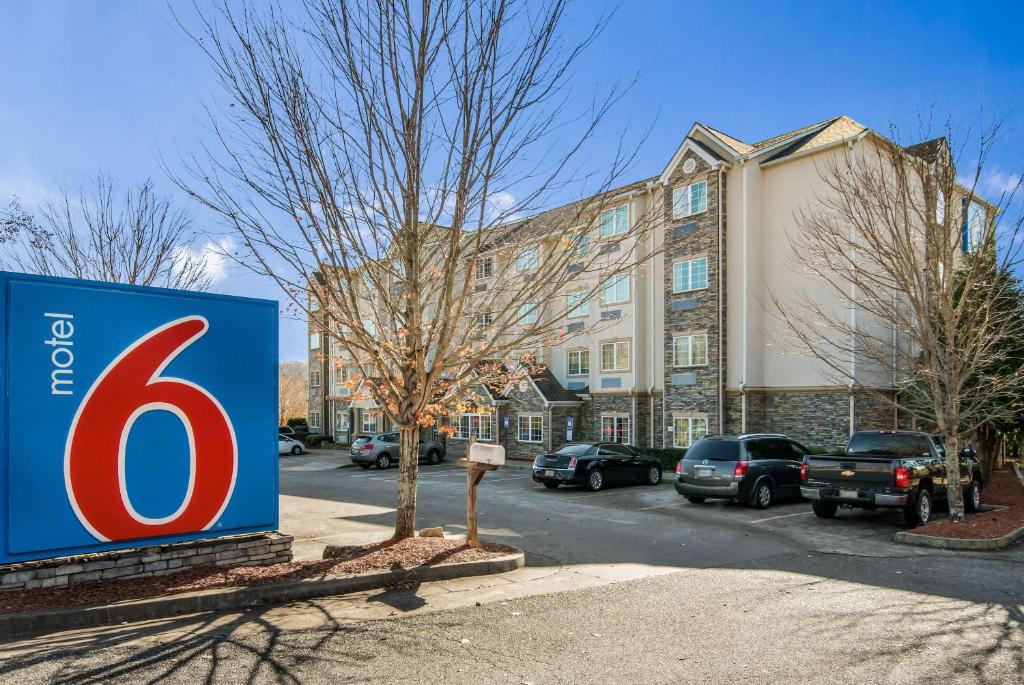 a blue and red sign in front of a building at Motel 6-Canton, GA in Canton