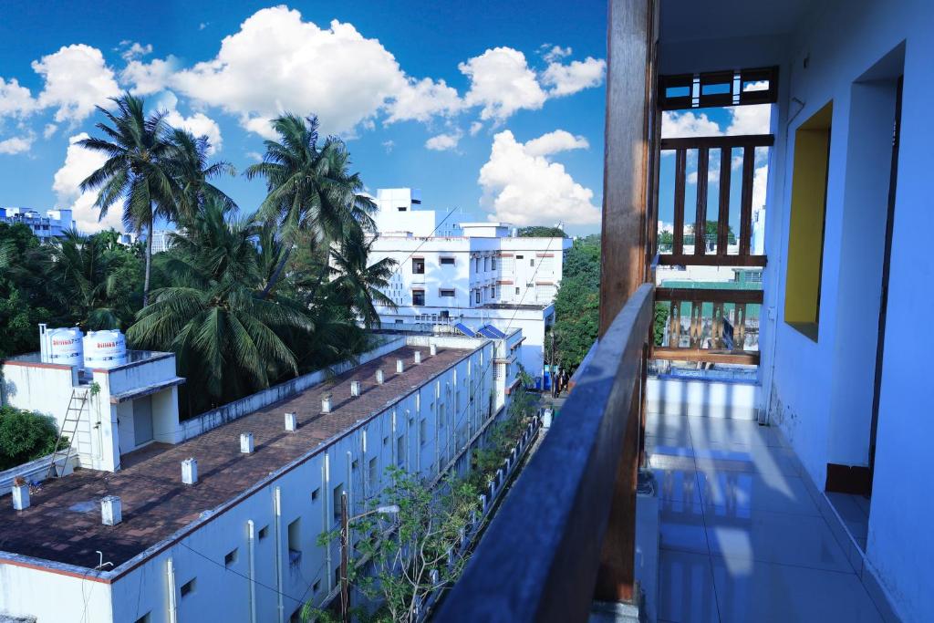 a view from the balcony of a building with palm trees at Manora Residency in Puducherry