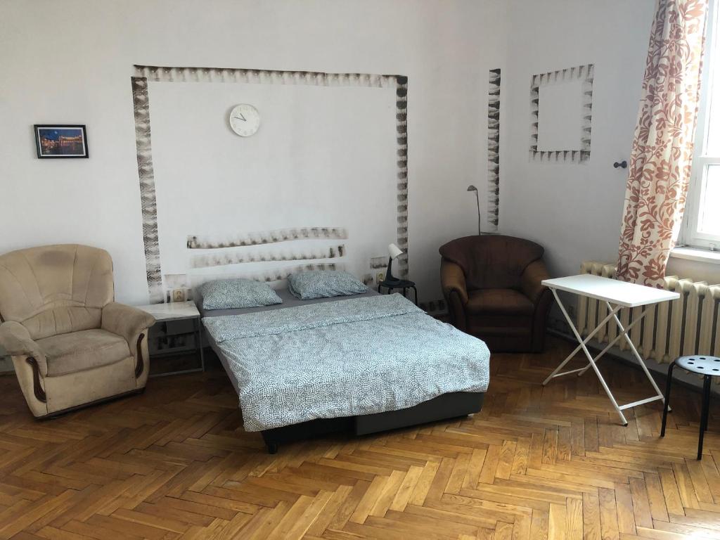 a bedroom with a bed and two chairs at Kiko 11B Room in Krakow
