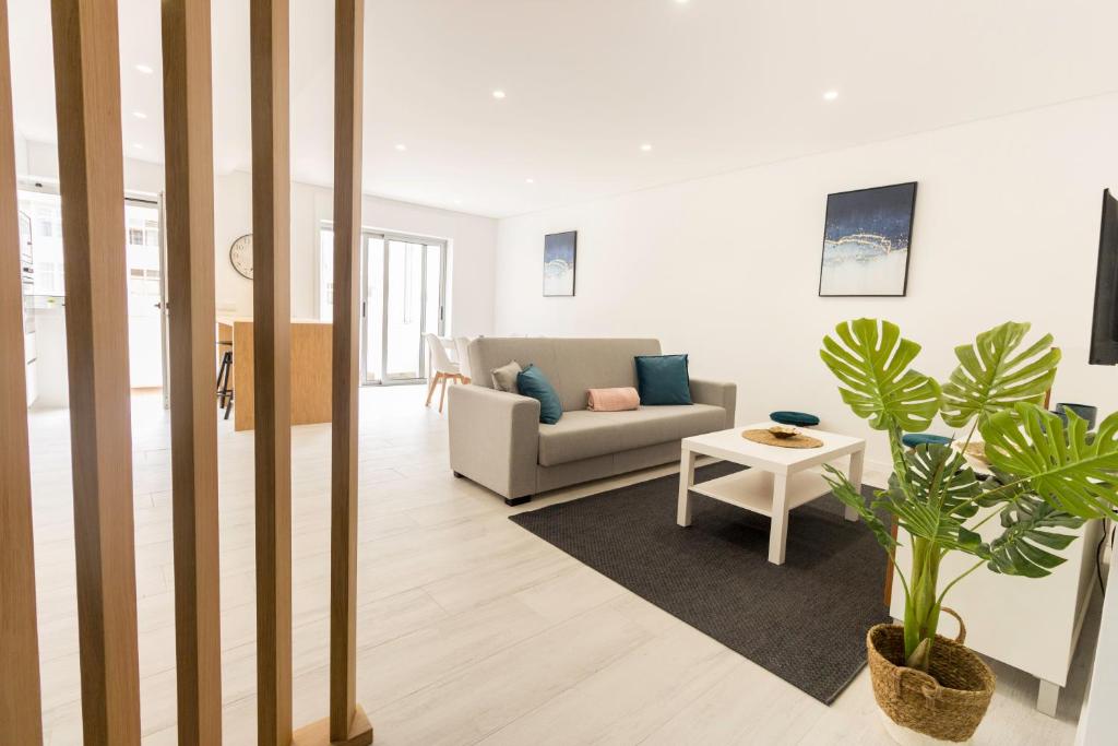 a living room with a couch and a table at Guest H4U POVOA PRACA JOAO 23 in Póvoa de Varzim