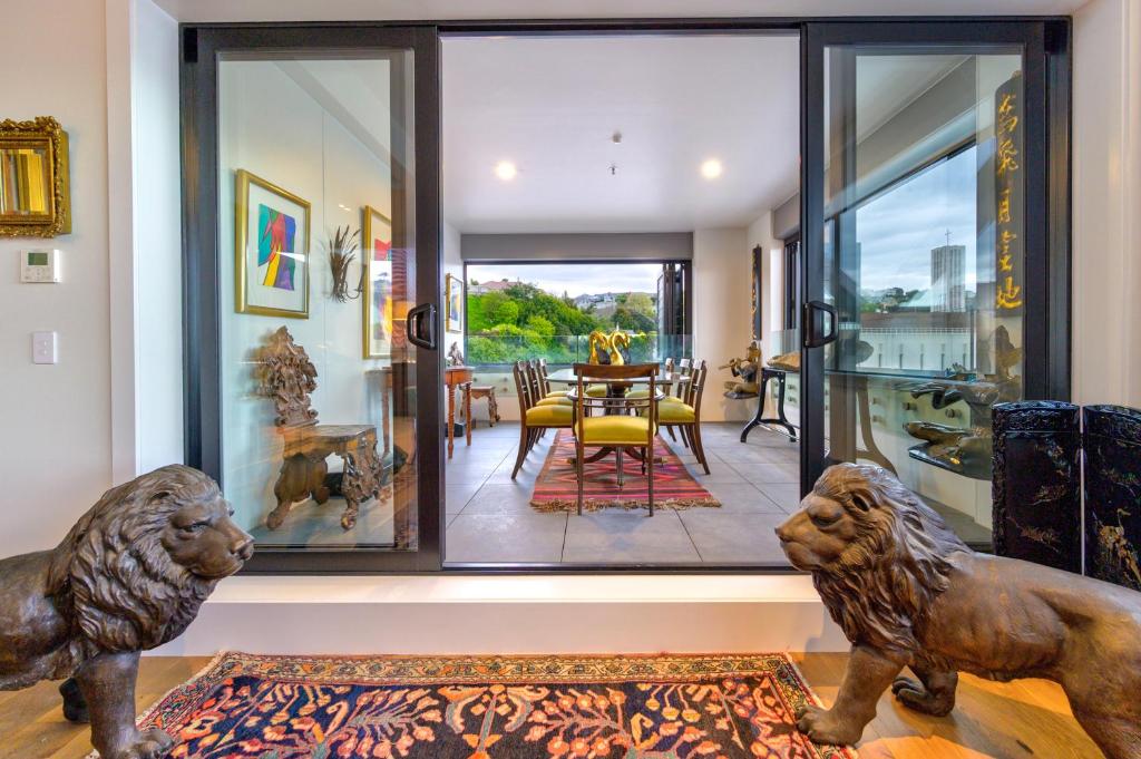 a home with two lions statues in the living room at The Address - Luxury 3 Bedroom Penthouse Apartment in Napier