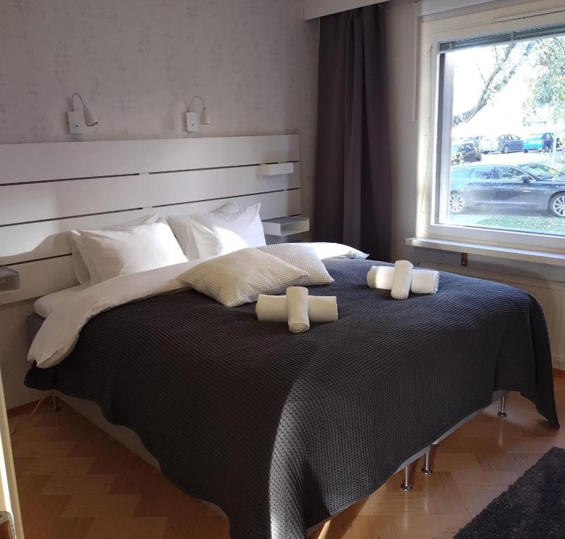 a bedroom with a large bed with two pillows on it at Asuntos-1 in Lahti