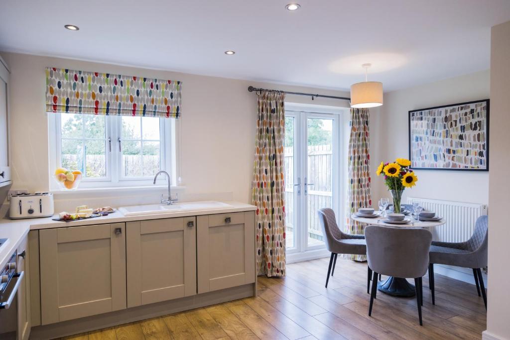 a kitchen and dining room with a table and a dining room at College Court in Bedale