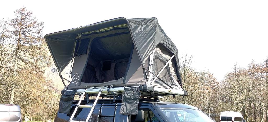 a truck with a cover on the top of it at Amelia Rooftop Tent Rental from ElectricExplorers in Hawkshead