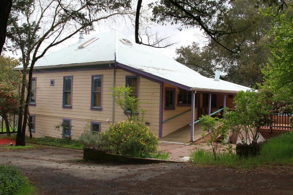 a small white house with a roof at Royal Nesu Retreat House in Geyserville