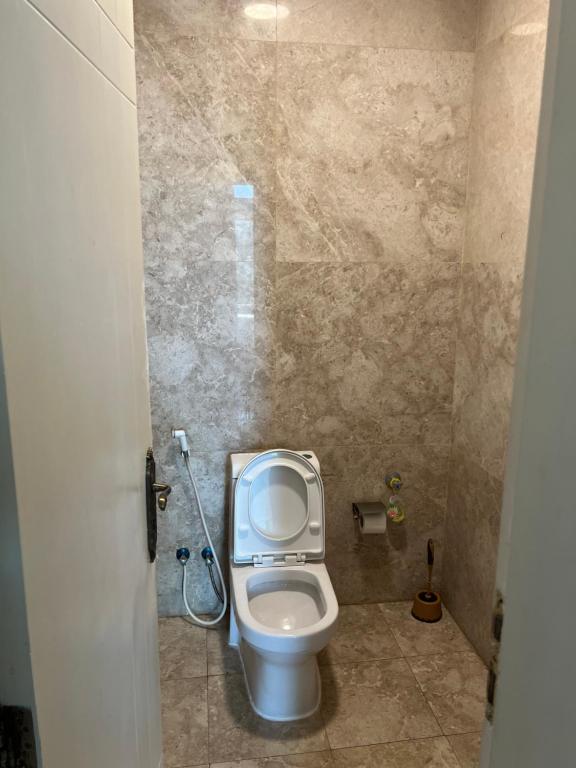 a small bathroom with a toilet in a stall at شاليه كادي cady resort in Al Khobar