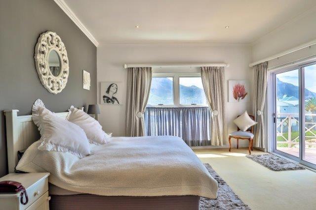 a bedroom with a large bed and a large window at Apartments Hout Bay in Cape Town