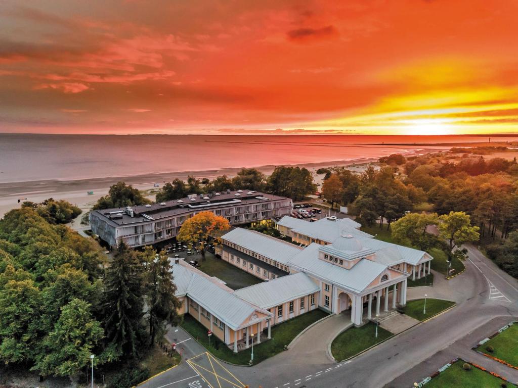 an aerial view of a building with a sunset at Hedon Spa & Hotel in Pärnu