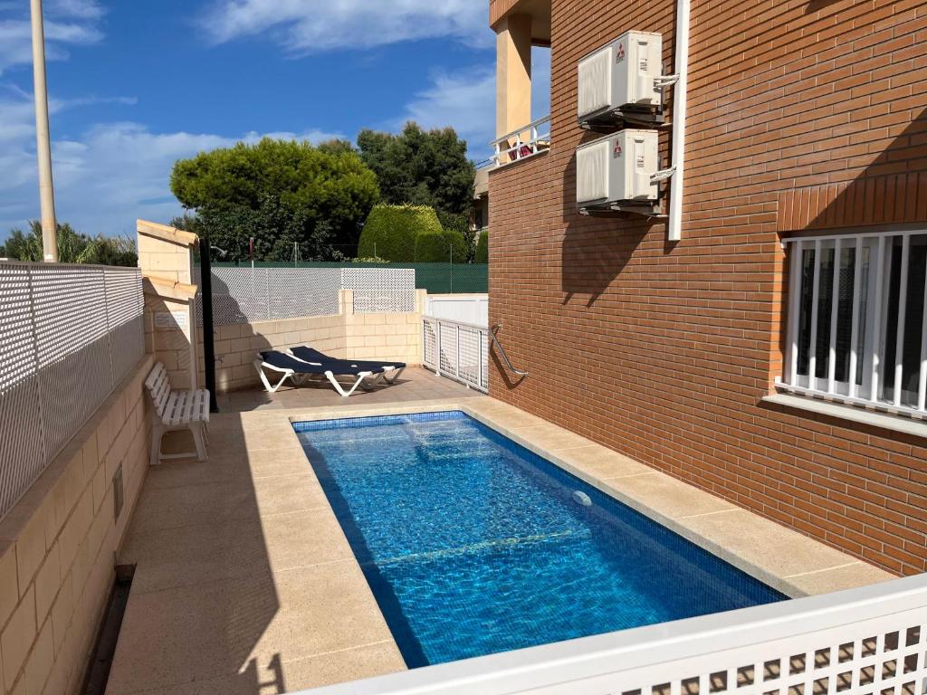 a swimming pool on the side of a building at OLIVA HOLIDAYS 1 in Oliva