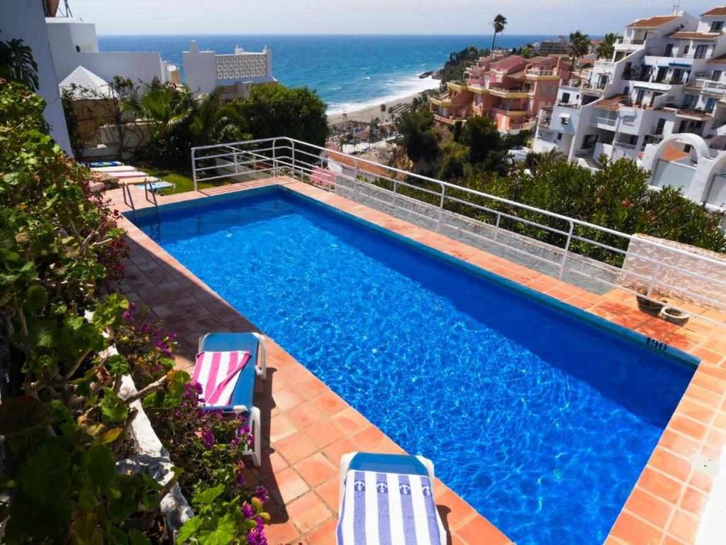 a swimming pool with a view of the ocean at Villa Azahara in Nerja