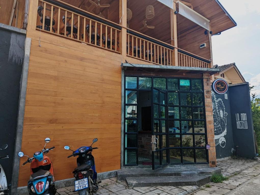 deux scooters garés devant un bâtiment dans l'établissement Supermoon Cozy Hostel, à Pai