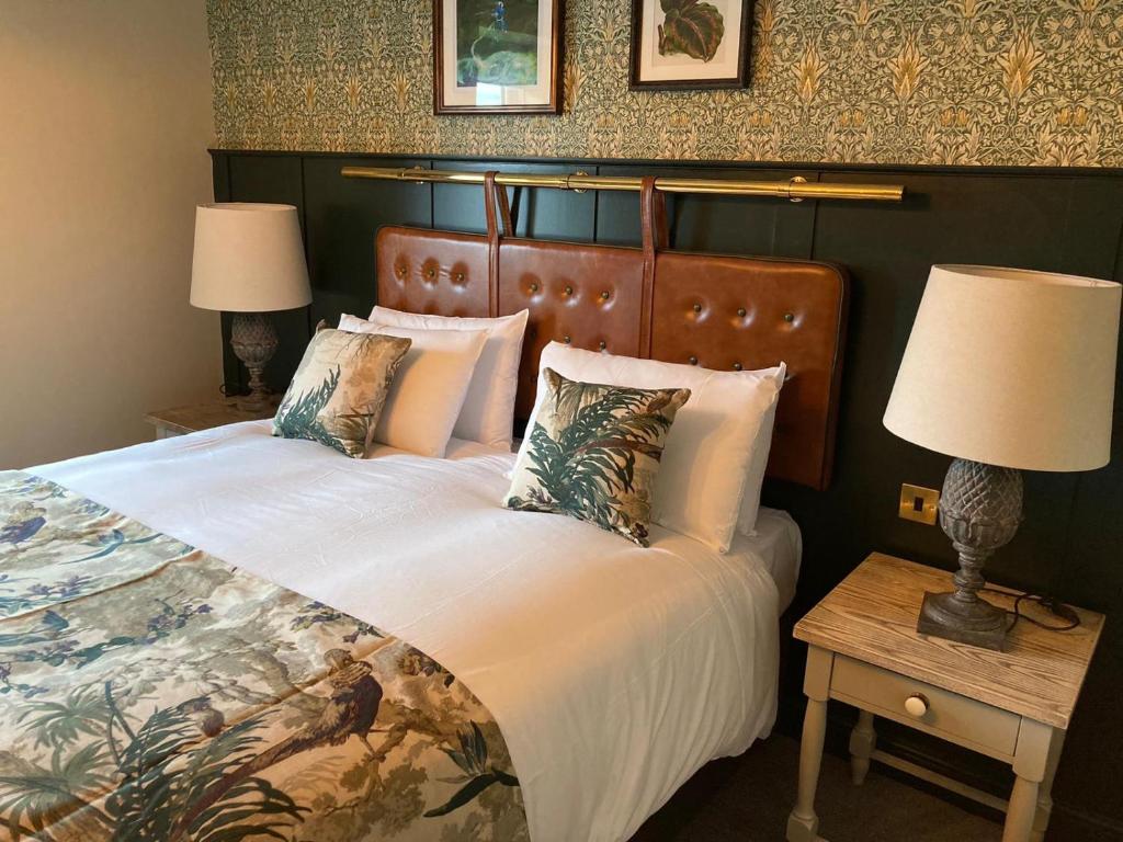 a hotel room with two beds and a lamp at The Red Lion Inn by Chef & Brewer Collection in Todwick