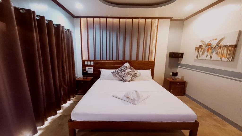 Postel nebo postele na pokoji v ubytování Hotel Oasis Port Barton