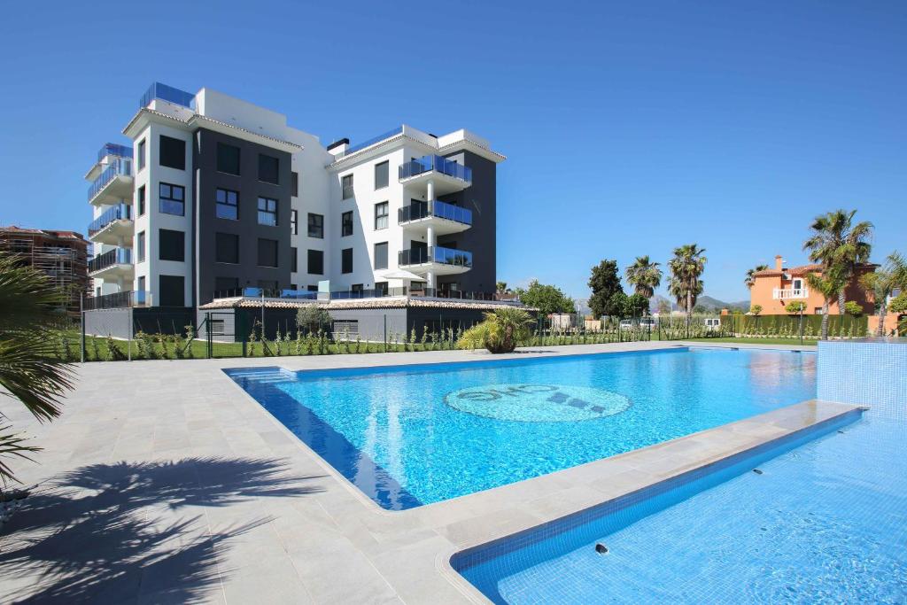 a large swimming pool in front of a building at Apartamentos y Villas Oliva Nova Golf Resort in Oliva