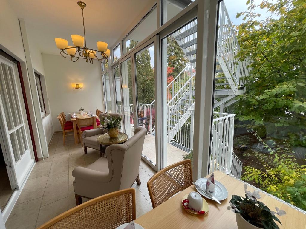 a room with a balcony with tables and chairs at Design-Boutique Hotel Vosteen in Nuremberg