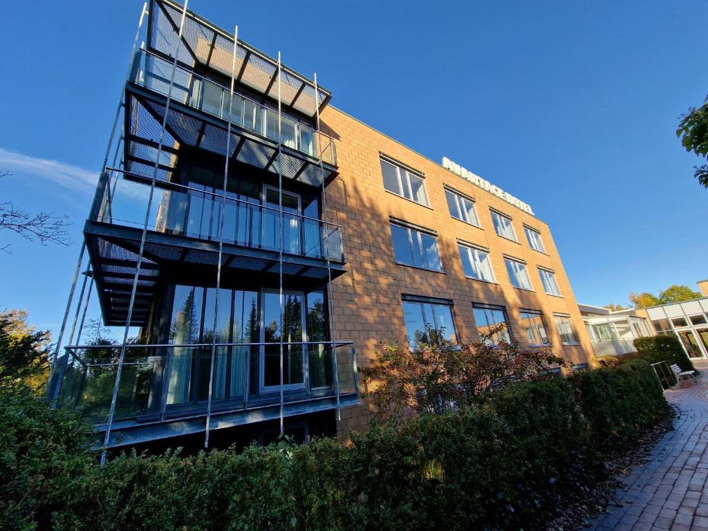 a brick building with a balcony in front of it at Nordic Avantage Hotel in Kiel