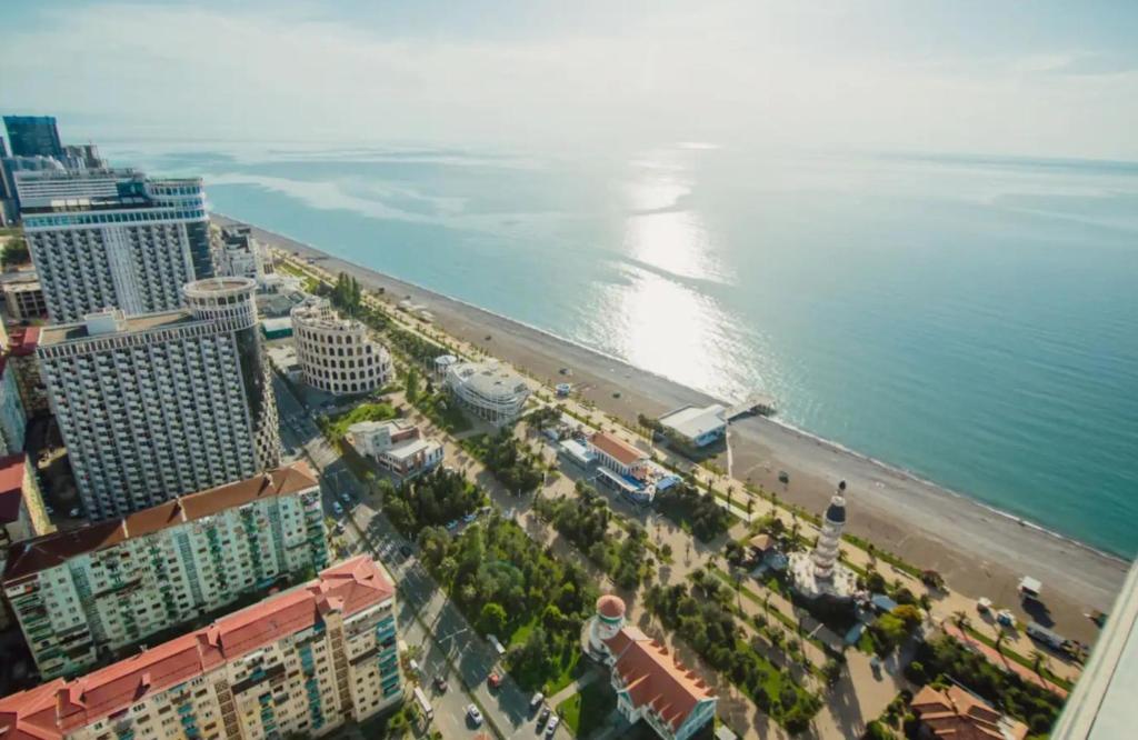 an aerial view of a beach and the ocean at Orbi City Beach Side Apartments in Batumi