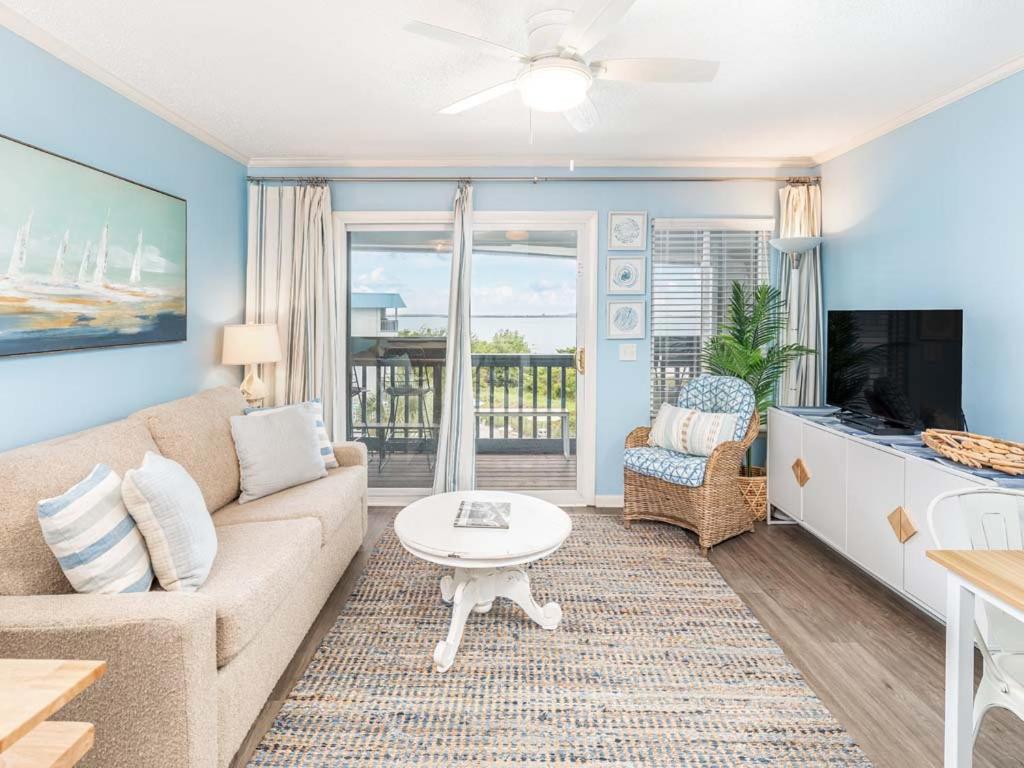 a living room with a couch and a table at Beach Racquet A315 in Tybee Island