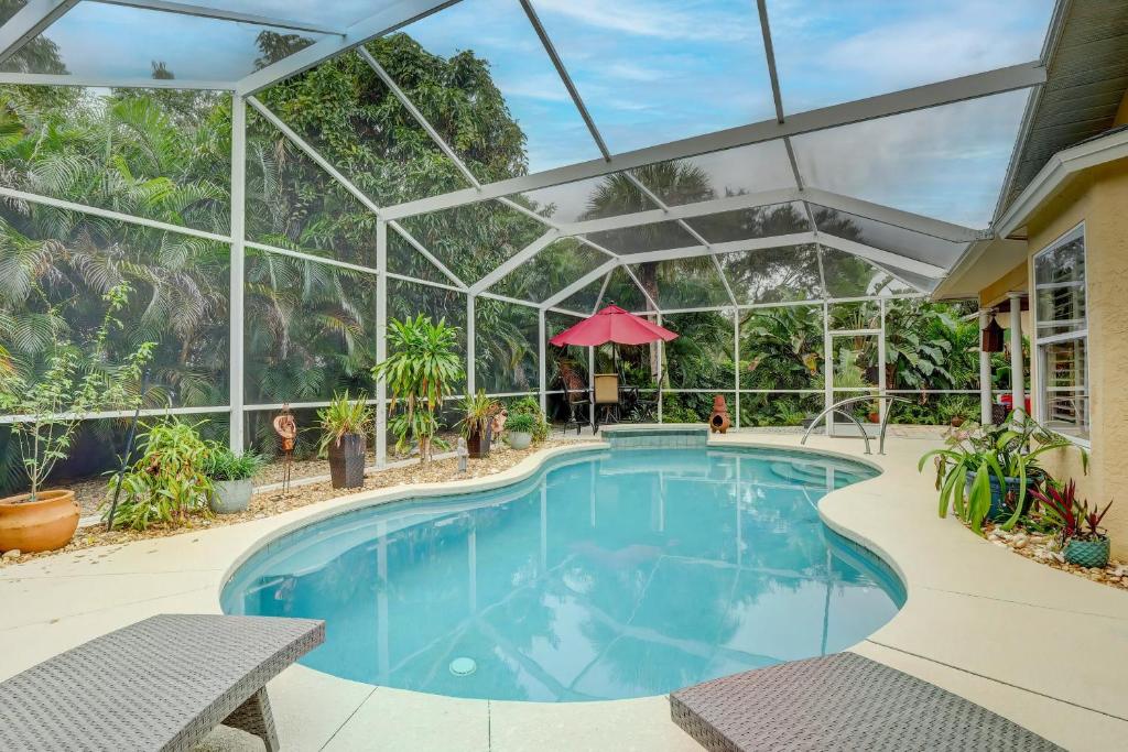 an indoor swimming pool with a glass ceiling at Pet Friendly Pool Home in River Reach of Naples FL in Naples